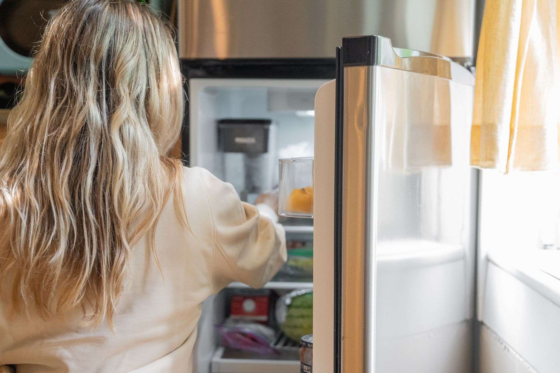 woman getting some foods in the refrigerator